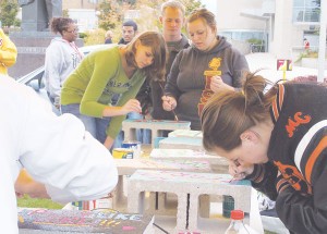 Painting Bricks <span class='credit'>Photo By: Kristyn Sonnenberg | Photo Editor</span><span class='description'>Students paint bricks with demeaning words to be built into a Wall of Oppression and displayed before being torn down by the community. Bricks are still available for painting between 11a.m. and 3p.m. today in the Quad.</span>